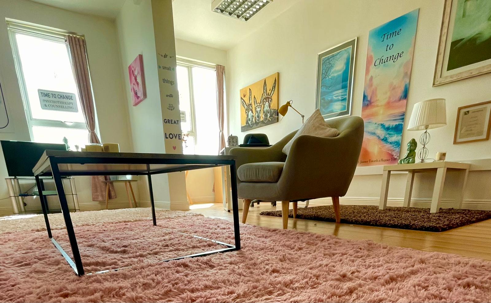 Comfortable therapy chair beside the 'Time to Change' artwork